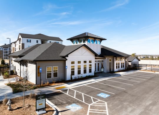 the exterior of a building with a parking lot and other buildings