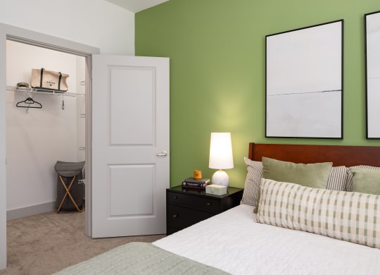 a bedroom with green walls and a white bed