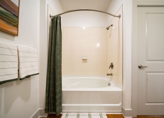a bathroom with a tub and a shower and a curtain