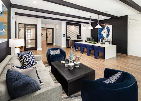 a living room and dining room with blue chairs and a table