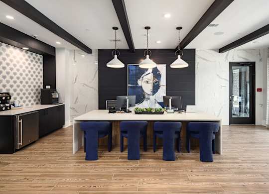 a dining room with a large table and blue chairs