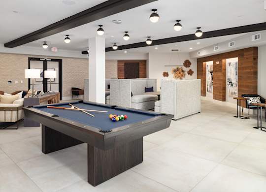 a clubhouse with a pool table in the middle of it