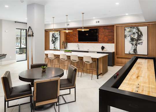 the kitchen and dining area of a modern house with a pool table