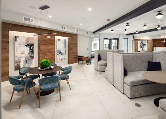 a living room with couches and a table and chairs