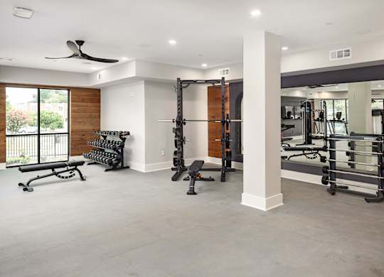 a gym with exercise equipment and a window
