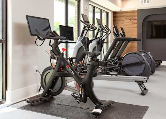 a row of exercise bikes in a gym