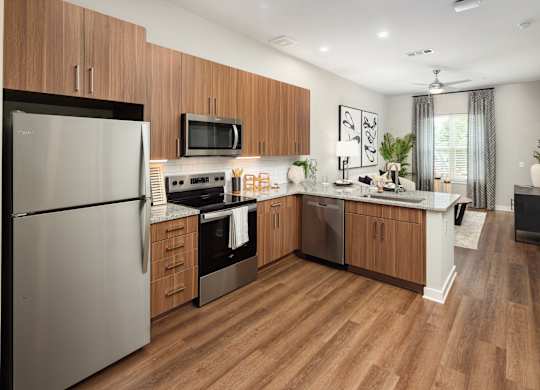 a kitchen with stainless steel appliances and wooden cabinets