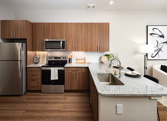 a kitchen with stainless steel appliances and granite counter tops
