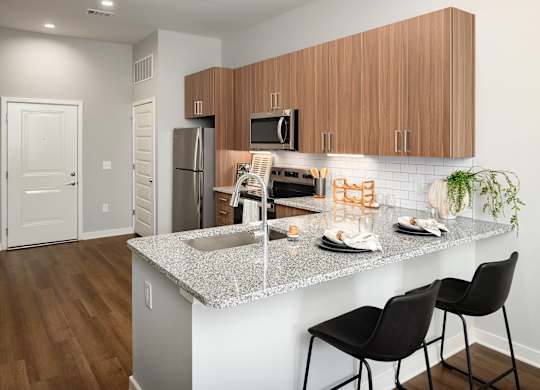 a kitchen with granite counter tops and stainless steel appliances