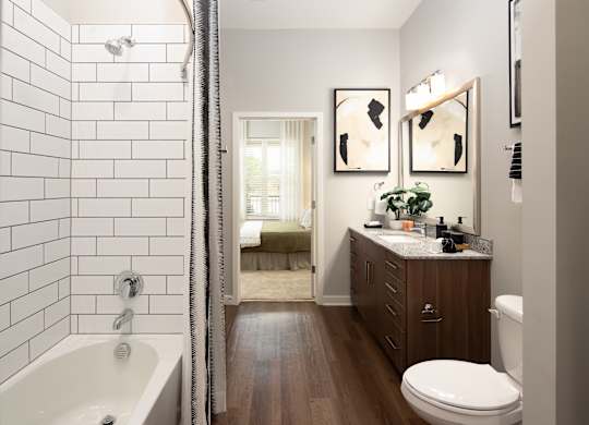 a bathroom with a shower and a sink and a toilet