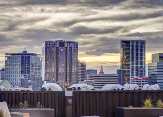 a view of the city skyline from a rooftop bar