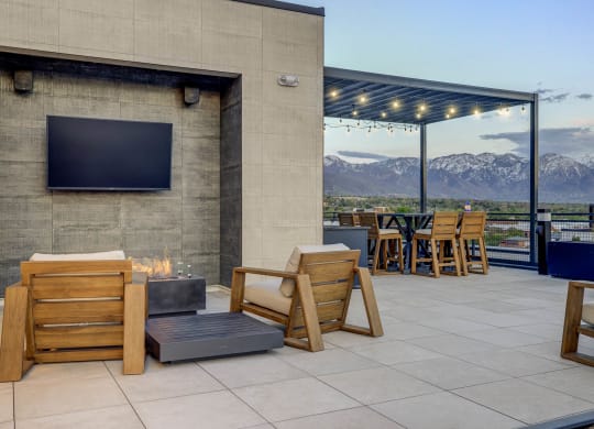 the patio has a fire pit and a tv on the wall