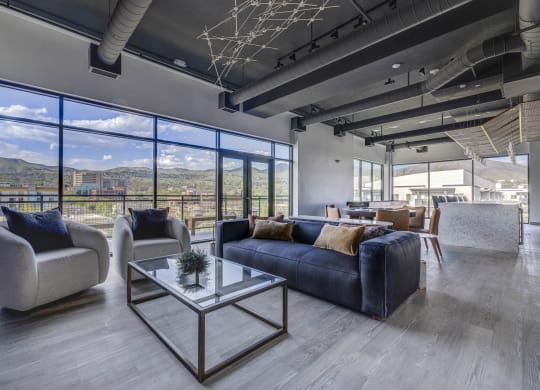 a clubroom with couches and chairs and a table