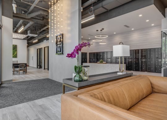 a lobby with a brown couch and a table