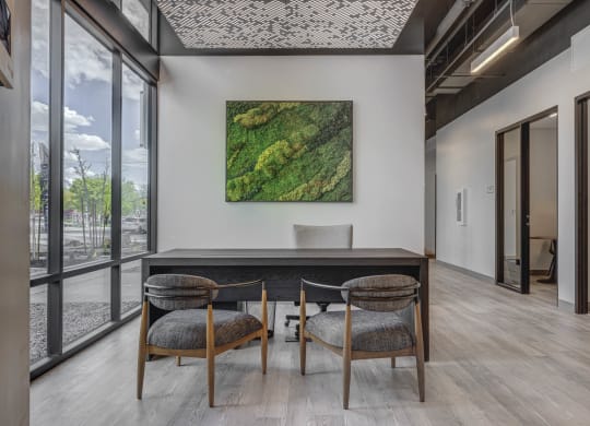 a working table with a table and three chairs