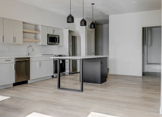 an empty kitchen with an island in the middle of it