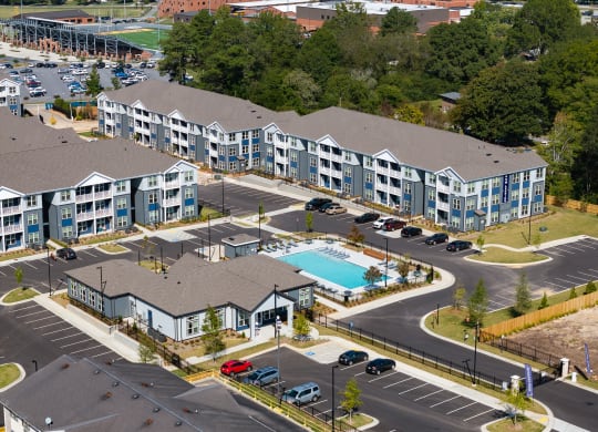 an aerial view of an apartment complex with a swimming pool