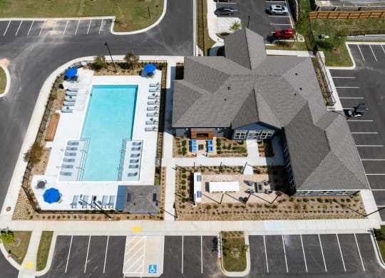 an aerial view of a building with a swimming pool