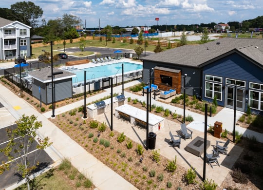 an aerial view of a community with a pool and buildings