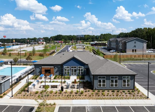 an aerial view of a building and a pool in a parking lot