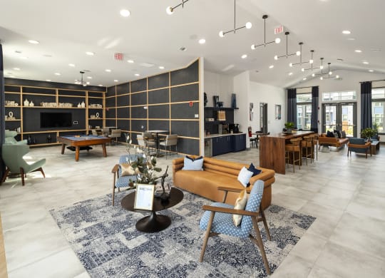 a lobby with couches tables and chairs and a pool table