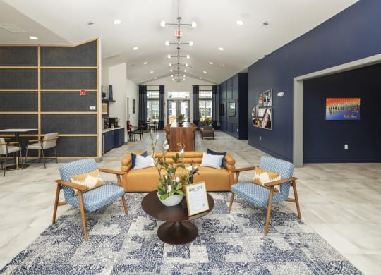 a lobby with a couch and chairs and a table