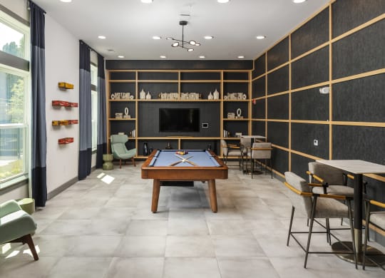 a game room with a pool table and a television