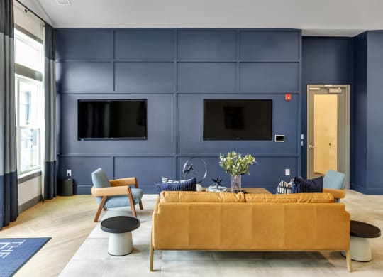 a living room with blue walls and a yellow couch