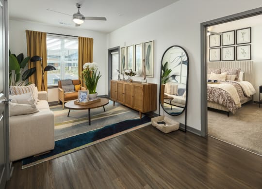 a living room with a mirror in front of a bedroom