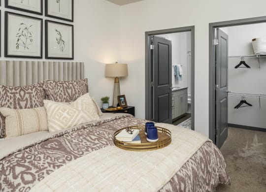 a bedroom with a bed and a door to a bathroom