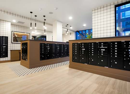 A room with black cabinets and a wooden floor.