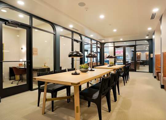 A conference room with a long table and chairs.