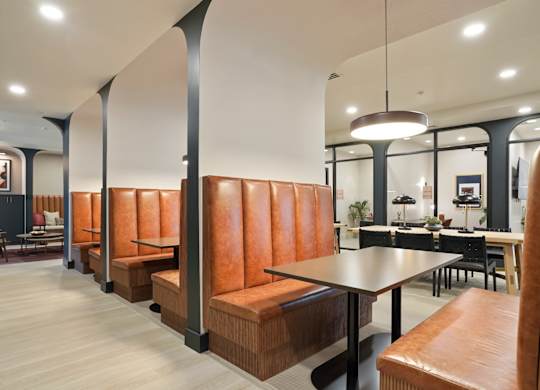 A modern dining area with a long table and chairs.