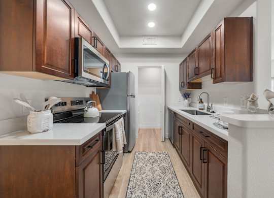 A kitchen with brown cabinets and a white countertop.