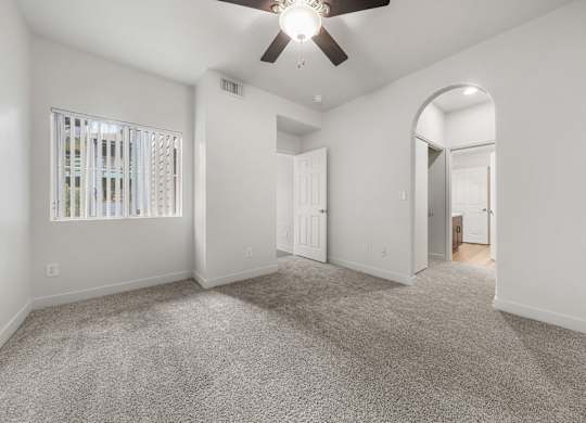 Inviting bedroom with ample natural light, neutral walls, and a thoughtfully designed layout.