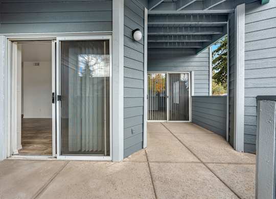 A house with a grey exterior and a glass door.