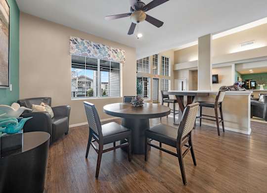 Cozy community center seating area with chairs and a self-serve coffee station.