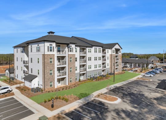 an aerial view of an apartment building with a parking lot