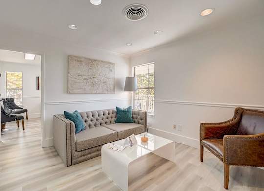 A living room with a grey couch and a coffee table.