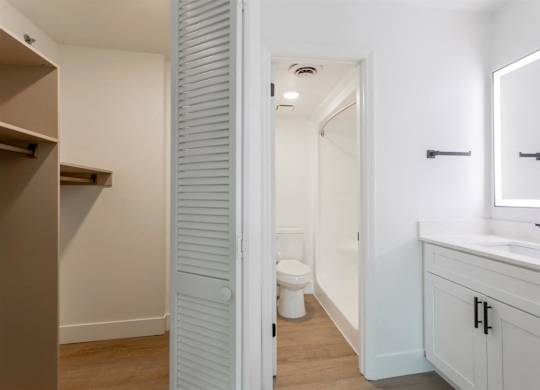 A white bathroom with a toilet and sink.