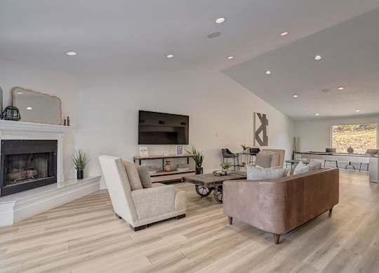 A modern living room with a fireplace and a large couch.