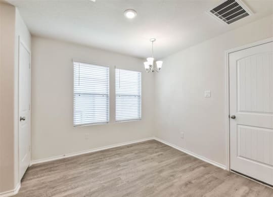an empty living room with a door and a window at The Village at Caney Mills, Texas, 77303