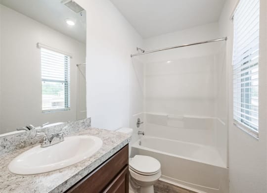 a bathroom with a sink toilet and a shower at The Village at Caney Mills, Conroe, Texas