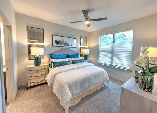 a bedroom with a bed and a window