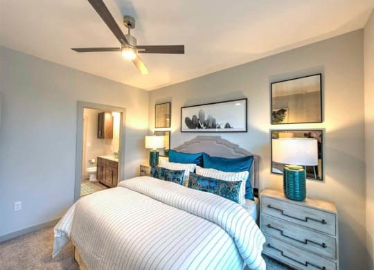 a bedroom with a bed and a ceiling fan