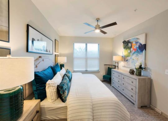 a bedroom with a bed and a ceiling fan