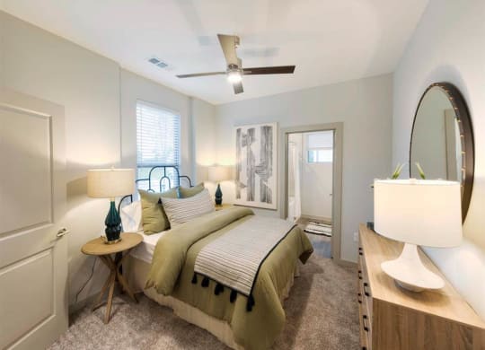 a bedroom with a bed and a mirror