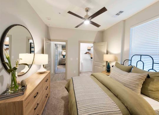a bedroom with a bed and a ceiling fan
