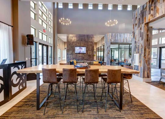 a large dining room with a wooden table and chairs