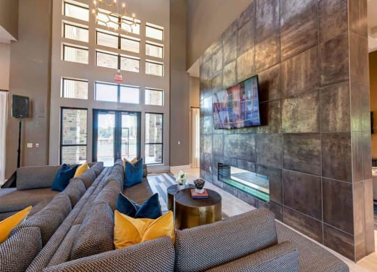 a large living room with couches and a fireplace